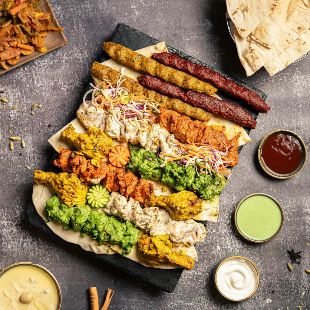 Delicious spread of Hakeem restaurant dishes, including vibrant kebabs, aromatic biryani, and fresh salads, beautifully plated https://hakeemrestaurant.in/